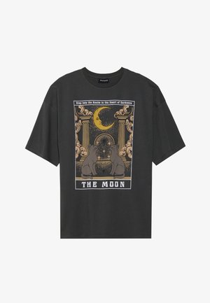 Dark gray oversized t-shirt with a graphic print featuring a crescent moon, columns, and two cats. Text below reads "THE MOON."