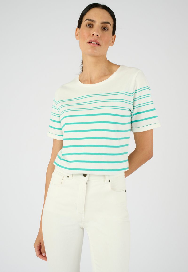 T-shirt à manches courtes en coton, avec des rayures horizontales teal sur fond blanc. Encolure ras du cou, coupe décontractée.