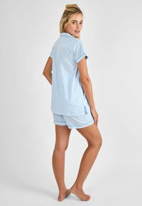 Lichtblauwe en witte gestreepte pyjama set, met een kortere mouwen knoopsluiting bovenstuk en bijpassende shorts met een ontspannen pasvorm en contrasterende afwerking.