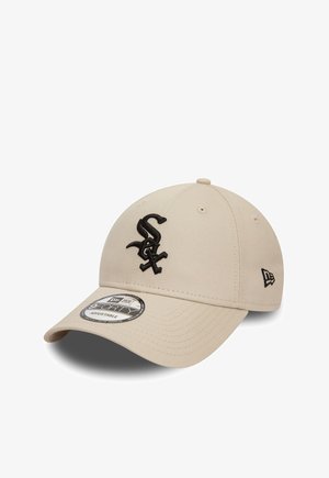 Beige cap made of fabric with a black embroidered logo on the front. Features a curved brim and an adjustable strap at the back.
