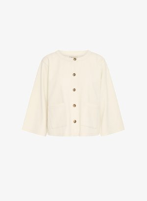 Elfenbensfärgad kort jacka med rund halsringning, knappstängning fram och två framfickor. Tillverkad av strukturerad tyg och har kontrasterande bruna knappar.