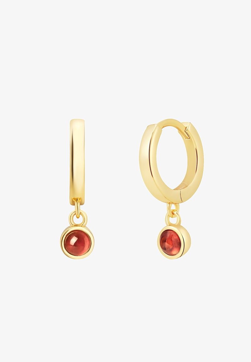 Zelta riņķa auskari ar apaļiem sarkaniem dārgakmeņiem, kas karājas no katra riņķa. Gluda apdare ar pulētiem akcentiem un drošu aizdari.