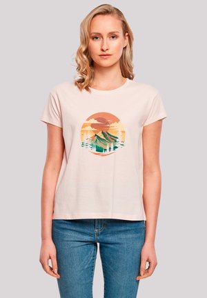 Light pink cotton t-shirt with short sleeves and a round neckline, featuring a printed mountain and sunset graphic in green, orange, and blue.