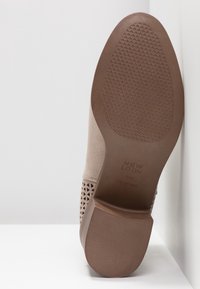Beige nubuk nilkkuri, jossa on reikäkuviointi, litteä ruskea kumipohja ja sileä tekstuuri kantapää. Brändin nimi "NEW LOOK" painettuna pohjaan.