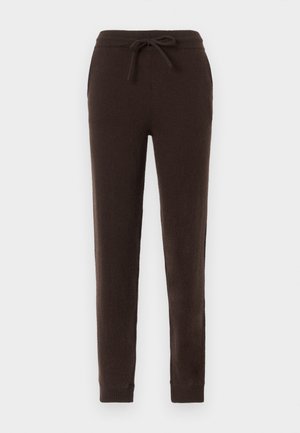 Brown sweatpants made of soft, textured fabric. Features an elastic waistband with a drawstring and ribbed cuffs at the ankles.