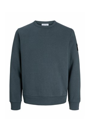 Sweat-shirt col rond bleu sarcelle foncé avec manches longues, poignets et ourlet côtelés, petite étiquette noire avec logo sur la manche supérieure gauche, aucun motif visible.