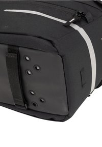 Borsa nera realizzata in tessuto resistente, dotata di una base piatta con sei fori circolari, una superficie testurizzata e una striscia riflettente sulla parte superiore.