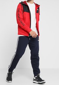 The North Face Fleecová bunda - red