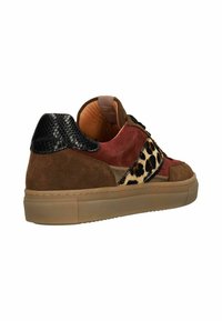 Multicolor sneaker featuring suede and leopard print accents, rubber sole, textured black heel, and contrasting laces.