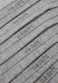 Gray socks with ribbed texture, featuring a blue stripe and embossed "c3-soft" logo along the top. Arranged in neat rows.