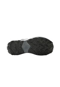 Semelle extérieure en caoutchouc noir avec des crampons de traction multidirectionnels, une section de semelle intermédiaire renforcée et une surface texturée pour une adhérence améliorée.