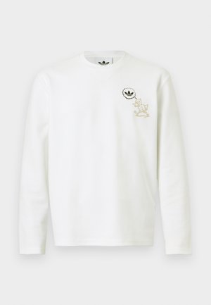 White long-sleeve textured shirt with small cartoon character and Adidas logo inside a thought bubble on left chest.