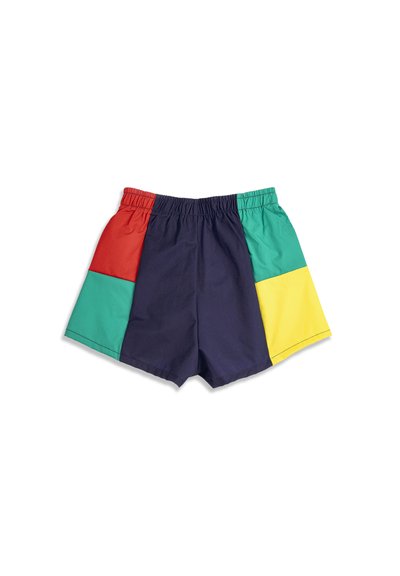 Elastic waistband shorts with color-block panels in navy, red, green, and yellow laid flat on white background.