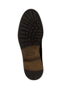 Semelle de chaussure en caoutchouc noir avec un motif de grip texturé, présentant une accent en cuir brun au talon et la marque "REDKINS" sur le côté.