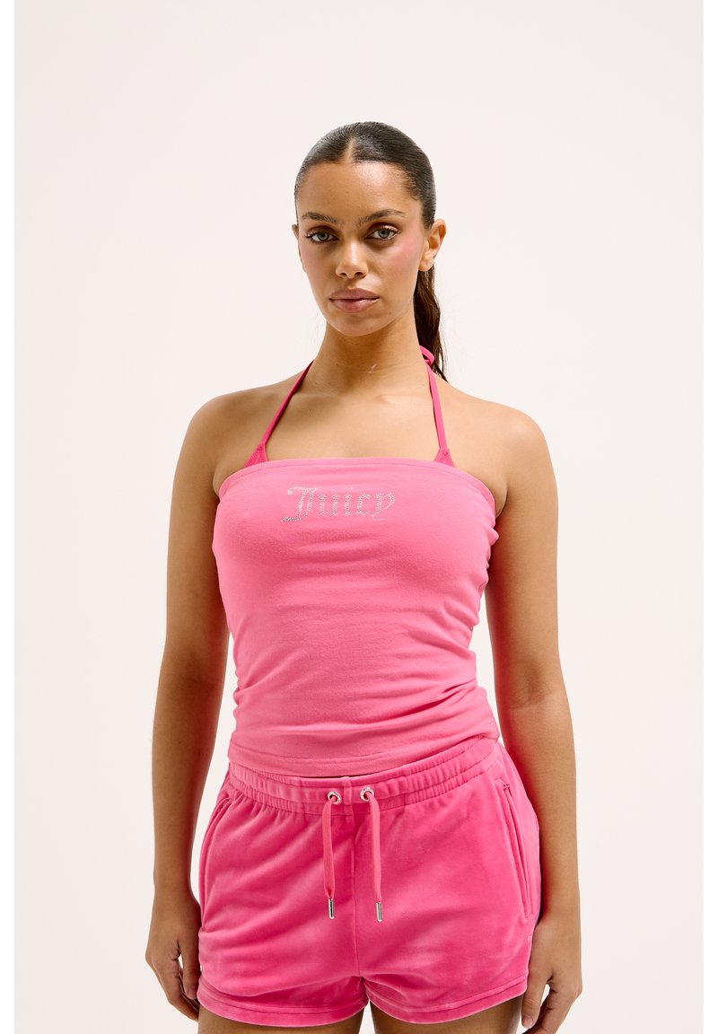 Pink halter top with "Juicy" text in rhinestones and matching pink velvet shorts with an elastic waistband and drawstring.