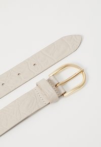 Beige leather belt with a textured pattern, featuring a gold-tone metal buckle and a stitched leather keeper.