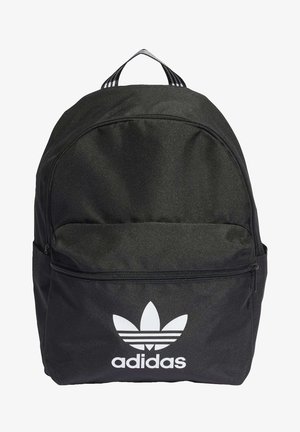 Black Adidas backpack with front zip pocket, white trefoil logo and text, and striped handle loop on top.
