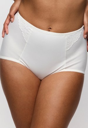 Witte naadloze onderbroek met hoge taille en kanten details, gedragen door persoon met handen op de heupen, tegen een effen achtergrond.