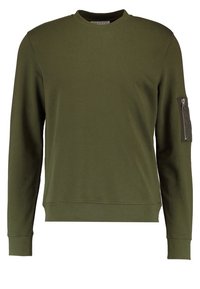 Felpa verde oliva con collo tondo, maniche lunghe e tasca con zip sul braccio sinistro. Realizzata in tessuto morbido con orlo aderente.