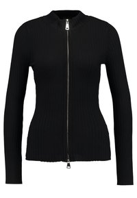 Pull en maille côtelée noir à col montant et à fermeture éclair, avec des manches longues ; présente une fermeture éclair argentée et un design ajusté.