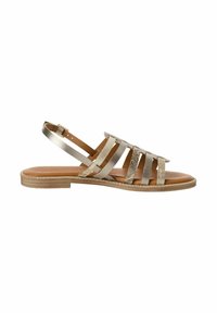 Strappy sandals with a metallic silver finish, featuring multiple straps, a padded footbed, and a flat sole with a textured edge.