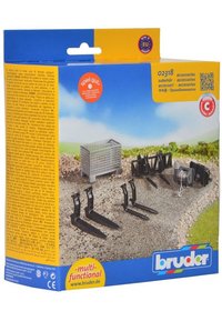 Bruder toy accessory set featuring a metal grid container, multiple black plastic forks, and a winch, all on a textured gravel surface.