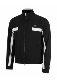 Chaqueta de chándal negra con un alto cuello, cremallera frontal completa, acentos de panel blanco, puños acanalados y cintura elástica. El material parece suave.