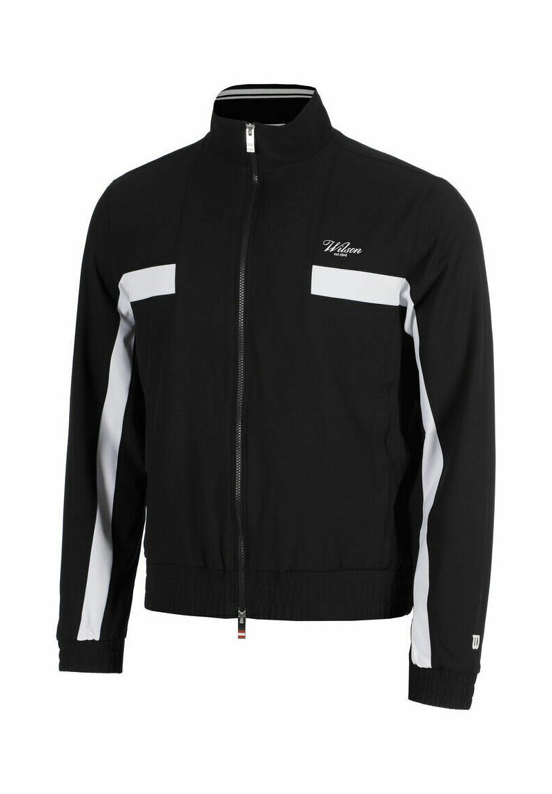 Chaqueta de chándal negra con un alto cuello, cremallera frontal completa, acentos de panel blanco, puños acanalados y cintura elástica. El material parece suave.