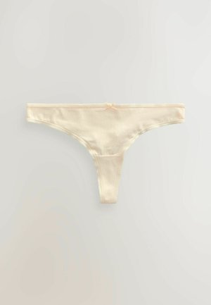 Tanga in cotone color crema con una texture morbida, una fascia sottile e bordi in pizzo delicati. Presenta un piccolo fiocco decorativo al centro.