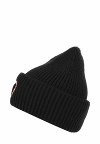 Black knitted beanie with vertical ribbing, pointed top, and a folded cuff. Features a small red and white logo patch on the cuff.