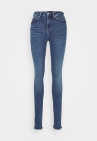 Calças skinny azul-escuras com cintura alta, apresentando uma textura desbotada, ligeiro desgaste e bainha desfiada nos tornozelos.