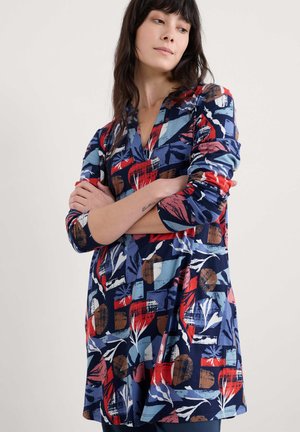 Langärmliges Kleid mit einem mehrfarbigen geometrischen und floralen Muster auf navy Hintergrund. Hergestellt aus weichem, dehnbarem Stoff mit V-Ausschnitt.