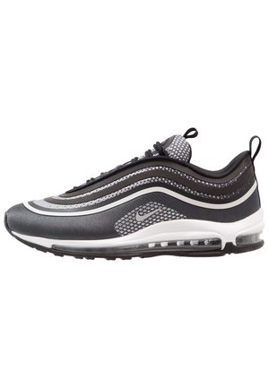 Baskets Nike Air Max 97 noires et grises avec des ondes réfléchissantes, semelle à coussin d'air visible, languettes de tirage sur la languette et le talon, vue côté droit.