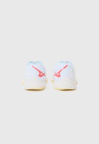 White athletic shoes with light blue and red accents, featuring a textured upper and a durable rubber sole, designed for sports performance.