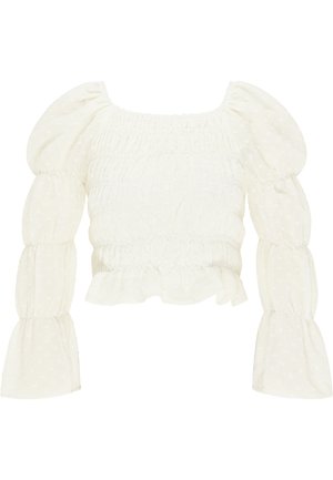 Fehér húzott blúz puffos ujjakkal, texturált anyag kis pöttyös mintával és fodros szegéllyel, négyzet alakú kivágással.
