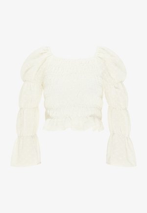 Fehér húzott blúz puffos ujjakkal, texturált anyag kis pöttyös mintával és fodros szegéllyel, négyzet alakú kivágással.