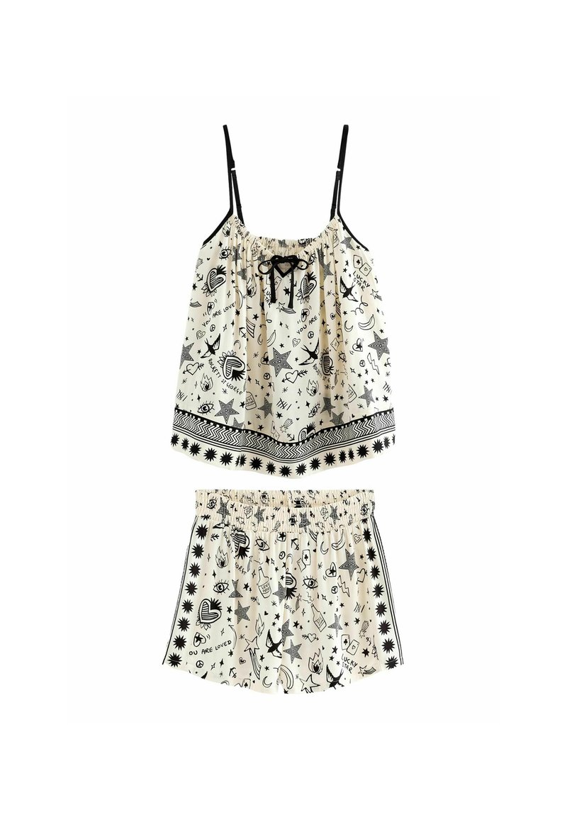 Lichtgewicht tweedelige set bestaande uit een top met spaghetti bandjes en shorts. De stof is crèmekleurig met een zwart patroon van harten, sterren en speelse ontwerpen.