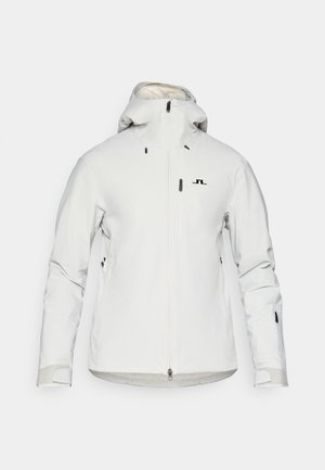 Weiße wasserdichte Jacke mit Kapuze, Reißverschlüssen und schwarzem Logo. Verfügt über verstellbare Ärmelbündchen und mehrere Reißverschlusstaschen. Glatte Stoffoberfläche.