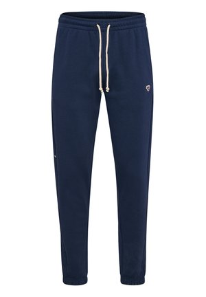 Marineblauwe sweatpants gemaakt van zachte stof, met een elastische tailleband met witte trekkoordjes en een klein logo op de linker bovenbeen.