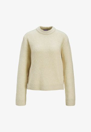 Light beige knit sweater with long sleeves, round neck, and textured finish. The fabric appears soft and cozy with a slightly cropped hem.