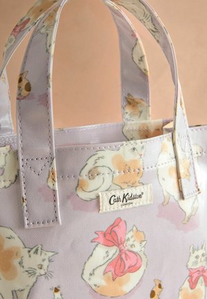 Small lavender tote bag featuring a cat print with various poses, pink bow accents, and a Cath Kidston logo tag on the side.