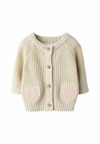Krämfärgad stickad cardigan med rund halsringning, träknappar och rosa hjärtapplikationer på fickorna. Korta ärmar och ribbad kant.