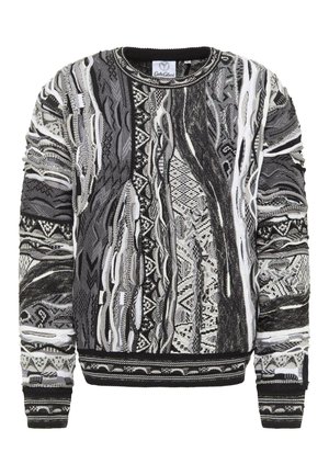 Black and white patterned sweater featuring abstract designs, round neckline, and ribbed cuffs and hem in a textured knit fabric.