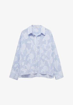 Cămașă albastră deschis cu broderie florală albă, model în dungi, mâneci lungi și un tiv curbat. Prezintă un buzunar pe piept.