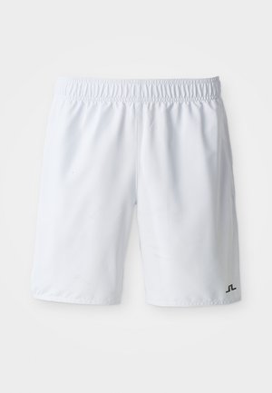 White athletic shorts with an elastic waistband and a small black logo on the lower right leg. Smooth, lightweight fabric.