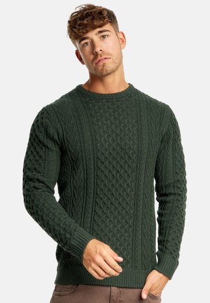 Green knitted sweater with textured patterns, featuring cables and diamonds. Ribbed cuffs and hem provide additional detail and fit.
