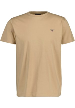 Beige cotton t-shirt with short sleeves, crew neck, and small embroidered logo on the chest. Smooth texture, minimalistic design.