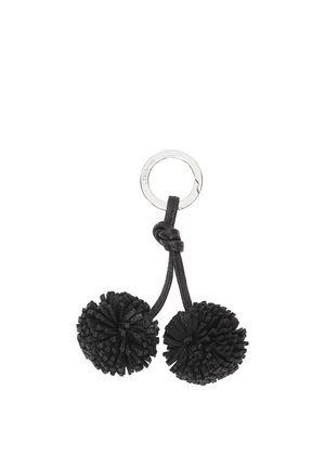 Metall-Schlüsselanhänger mit zwei schwarzen, strukturierten Bommel, die an einem geknoteten Lederband befestigt sind.