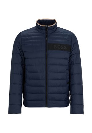 Veste matelassée marine avec texture matelassée, col montant, fermeture éclair sur le devant et patch logo noir sur la poitrine, dotée de poches latérales et de poignets élastiques.