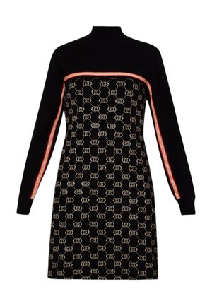 Woman wearing a black patterned long-sleeve dress with a red stripe detail paired with black knee-high textured heeled boots.